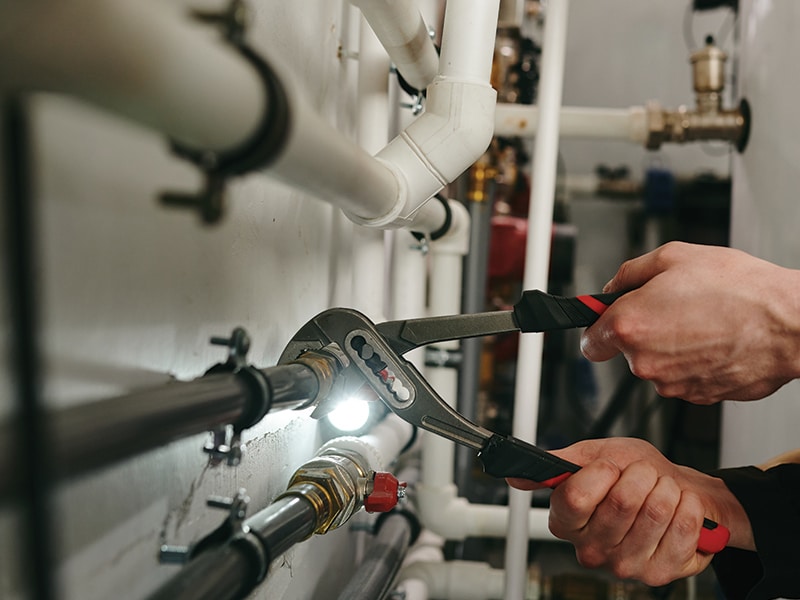 plumber working on water heater repair