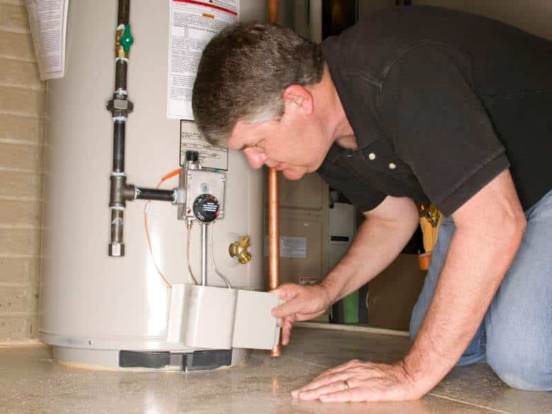 plumber performing hot water heater repair
