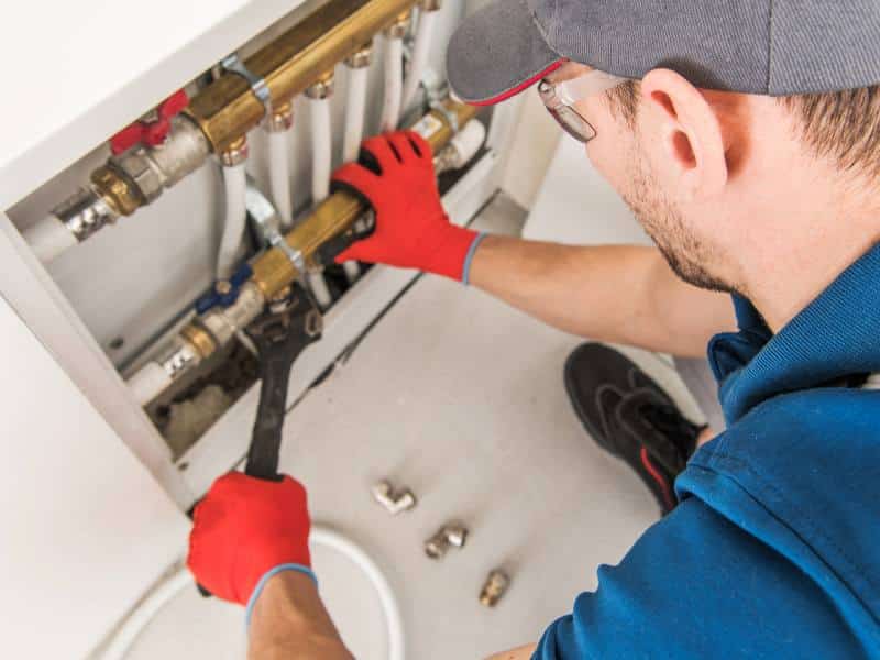 plumber working on a home's plumbing system