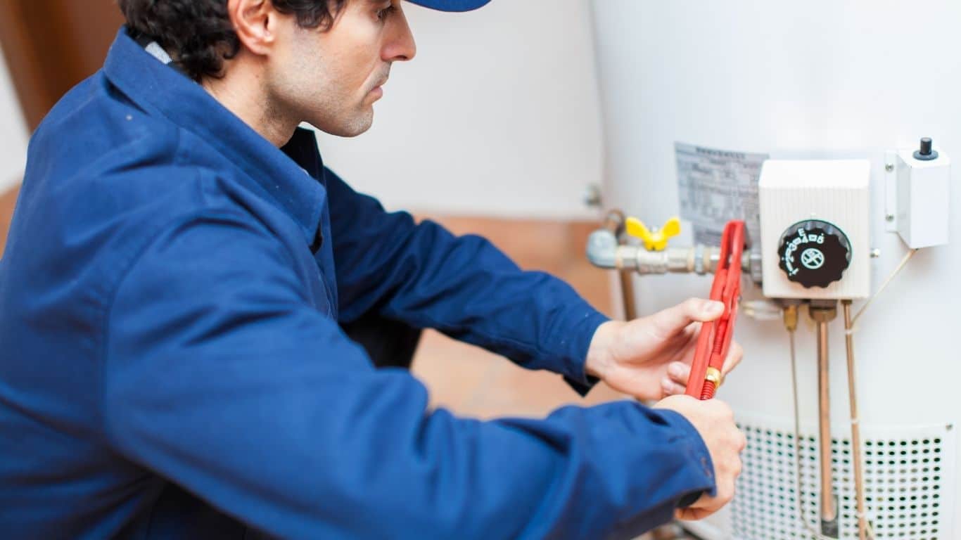 plumber flushing a water heater